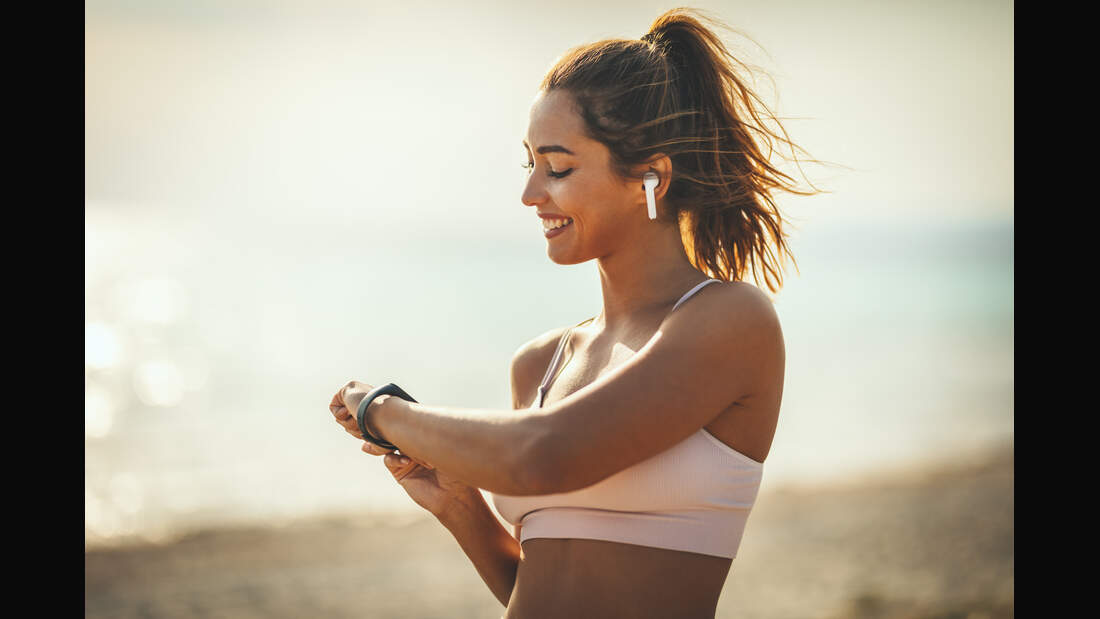A,Beautiful,Young,Woman,Is,Looking,At,Smartwatch,And,Preparing