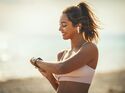 A,Beautiful,Young,Woman,Is,Looking,At,Smartwatch,And,Preparing