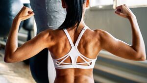 Close,Up,Of,Woman,Back,With,Flexing,Her,Muscles,In