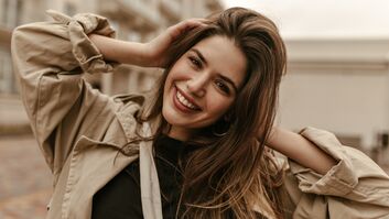 Cute,Cheerful,Lady,In,Black,Top,And,Trench,Coat,Smiles