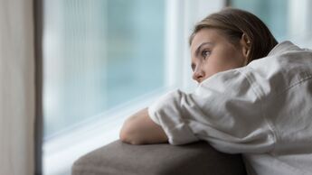 Lonely,Young,Woman,Lies,On,Sofa,,Looking,Out,Window,,Having