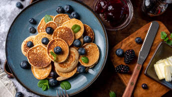 Mini,Pancakes,On,A,Plate,With,Blueberries,,Jelly,And,Butter.