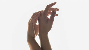 Woman Raising Hands Against A Window
