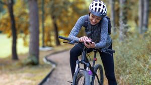 Young,Smiling,Woman,In,A,Tracksuit,On,A,Mountain,Bike