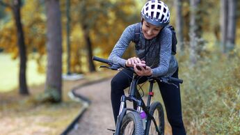 Young,Smiling,Woman,In,A,Tracksuit,On,A,Mountain,Bike